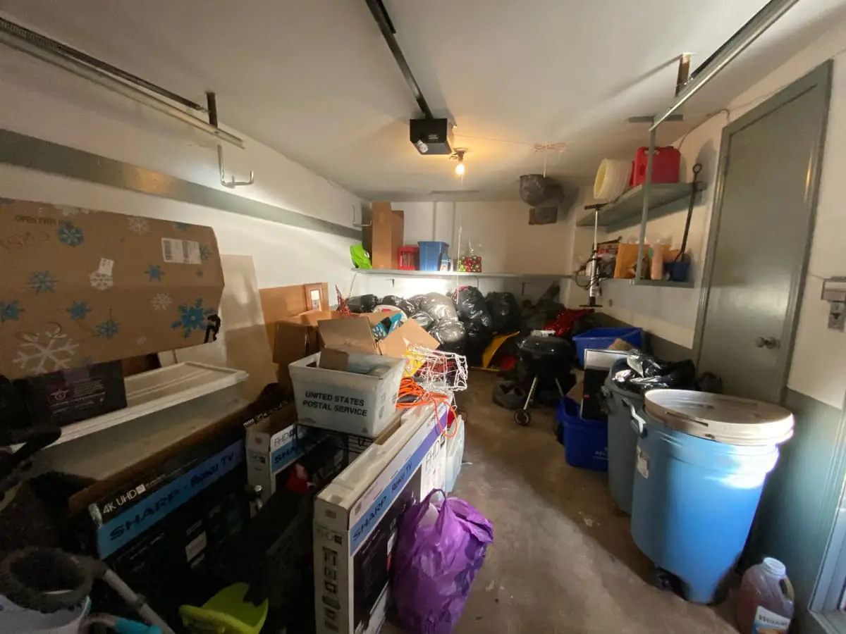 Selling a house after a life change in Baldwin: garage stacked with bins and stored furniture