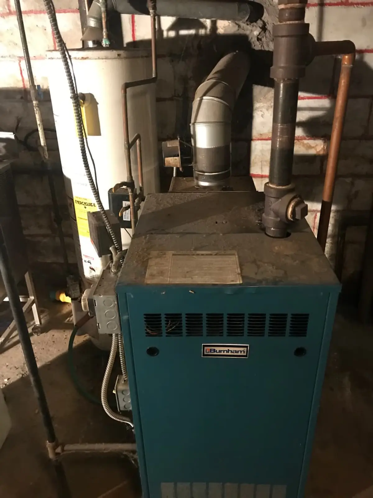 Downsizing or retiring in Baldwin: old boiler and water heater in a cinder-block basement