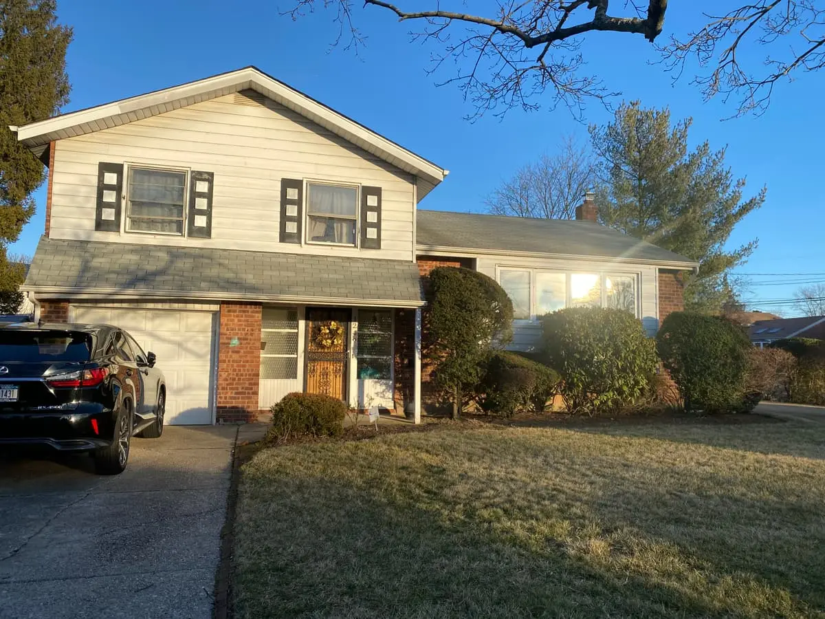 Wondering which Baldwin neighborhoods we buy in: split-level with a brick-faced garage and a front lawn