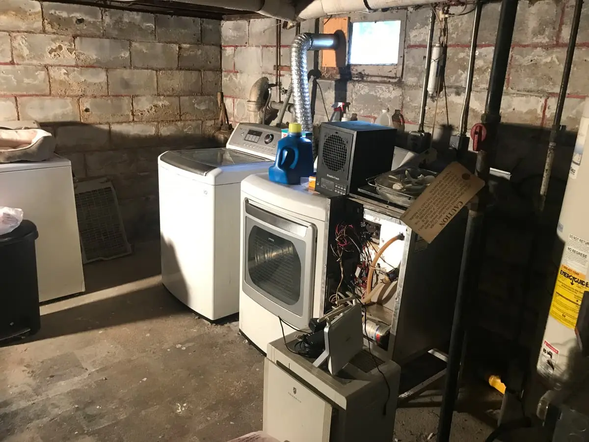 Selling estate property as an executor in Baldwin: unfinished basement with old appliances and a washer